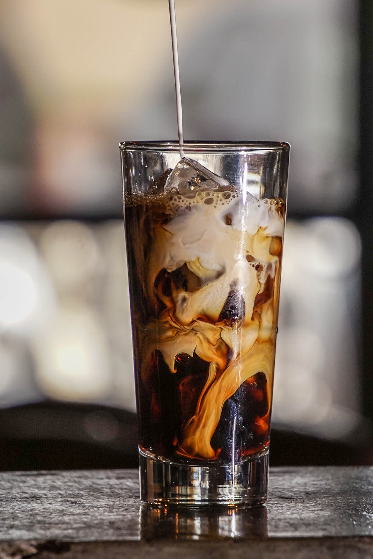 cold brew coffee with swirls of milk.