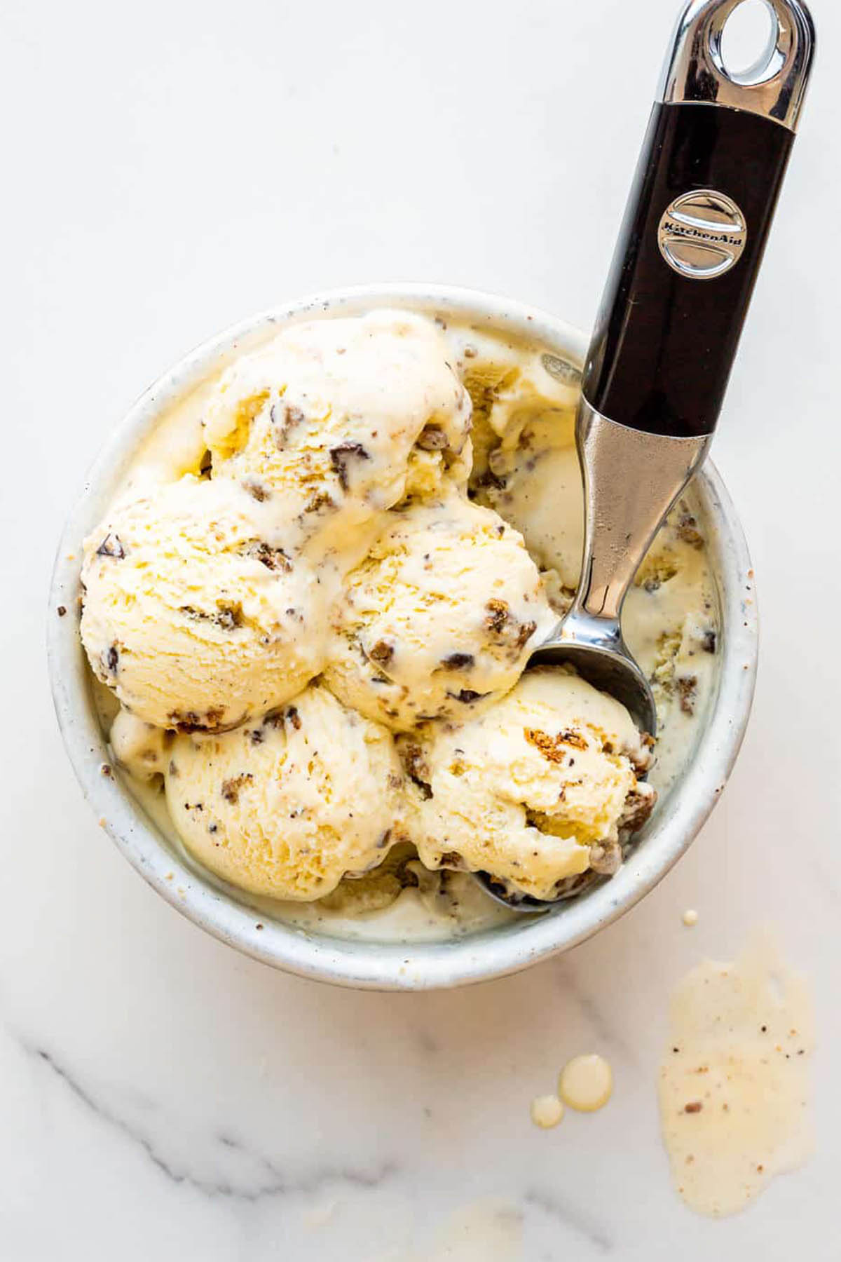 cookie ice cream in a bowl with ice cream scoop.