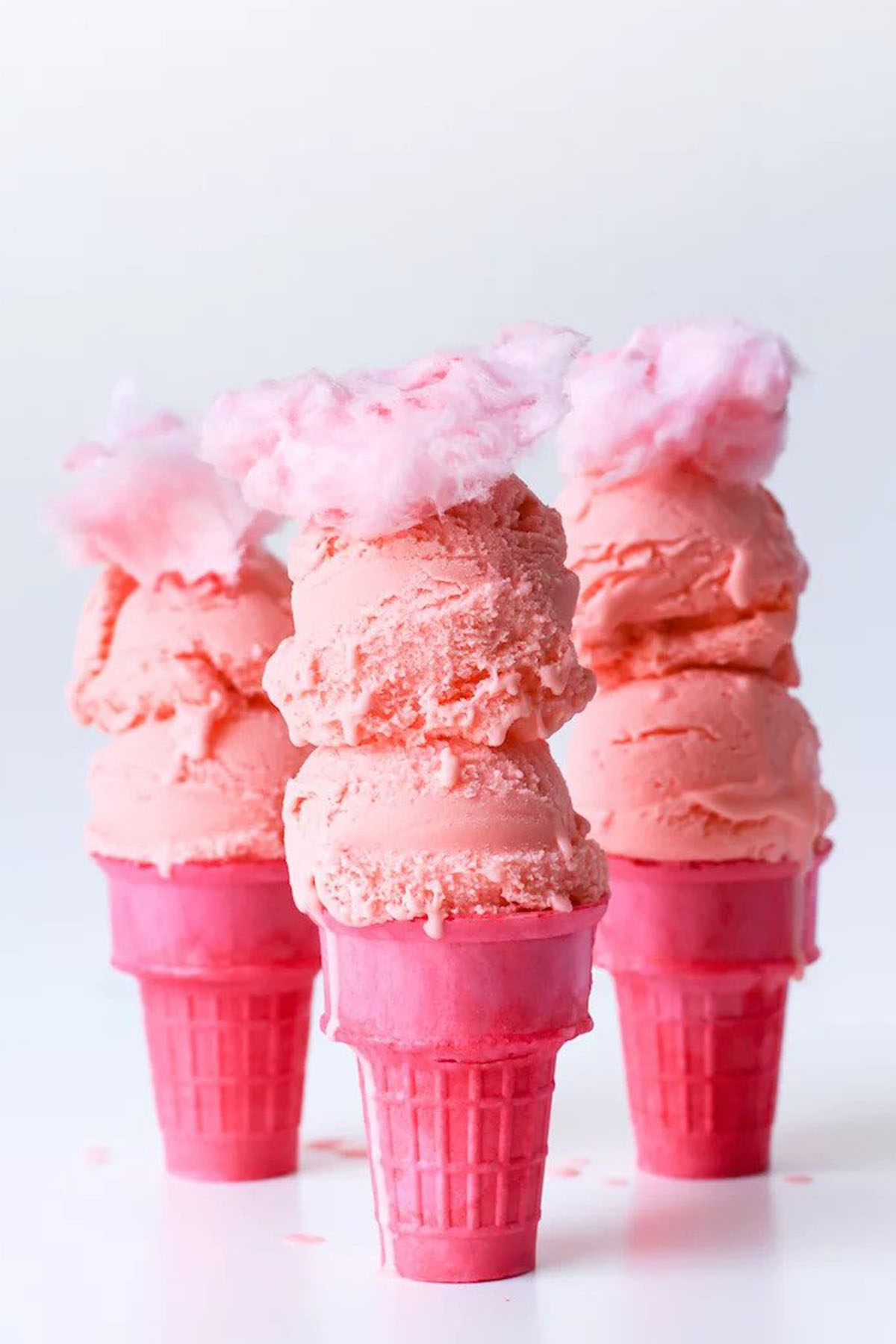 pink cotton candy ice cream on a pink cone.