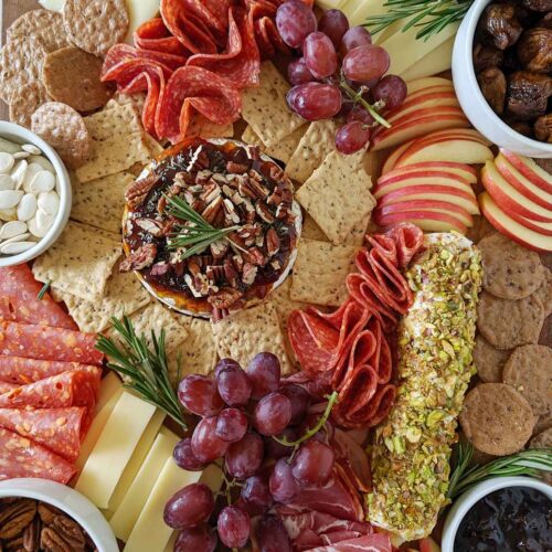 fall cheese board filled with various food items.