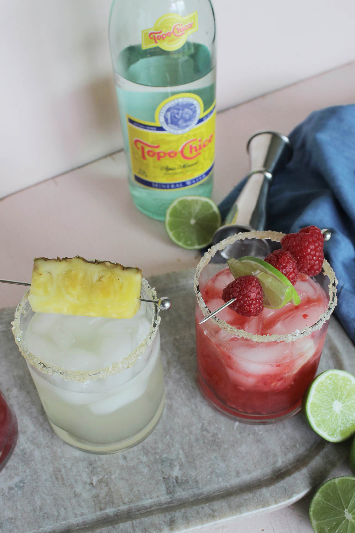 fruit flavored margaritas next to Topo Chico water.