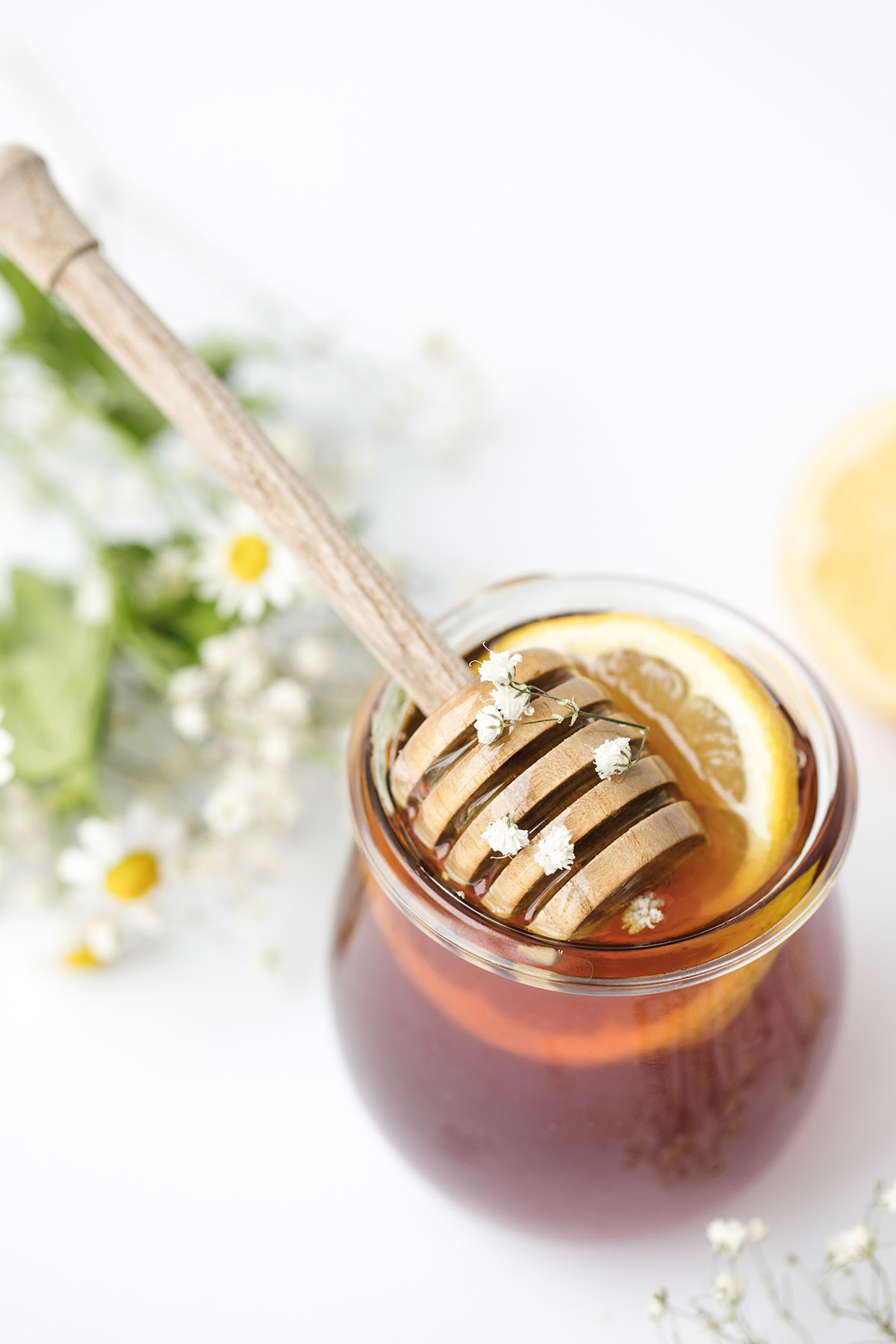 jar of honey with a lemon slice.