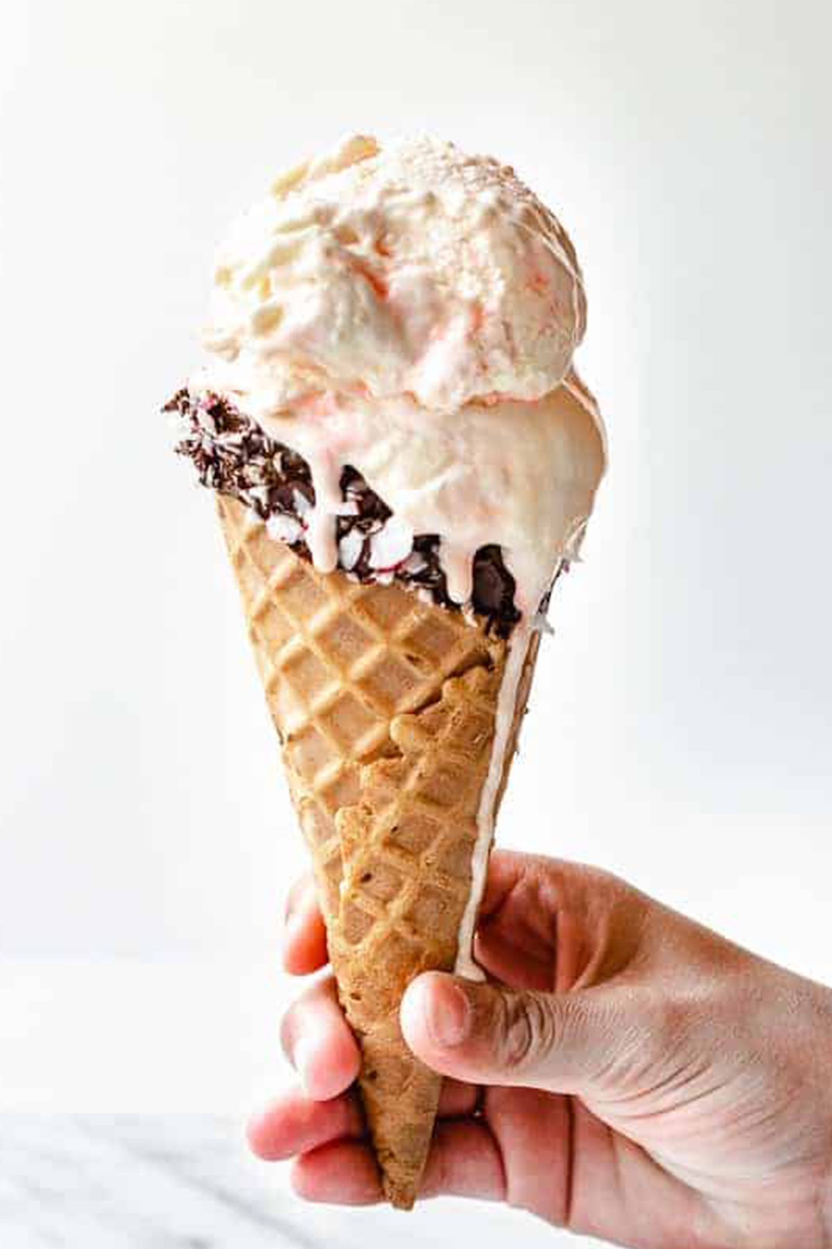 white chocolate peppermint ice cream in a chocolate dipped cone.
