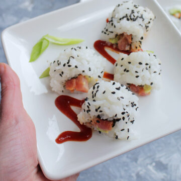 spicy tuna sushi roll on white serving plate.