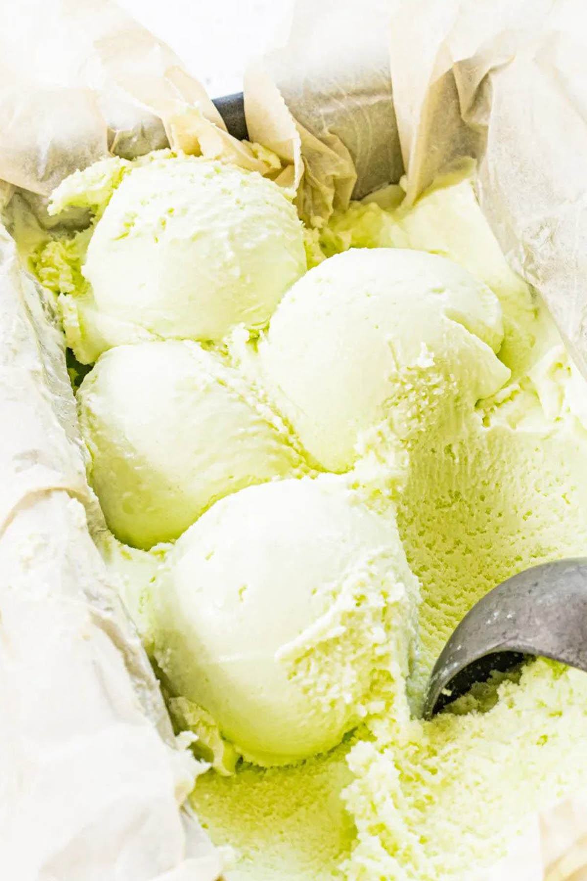scoops of green ice cream in loaf pan.