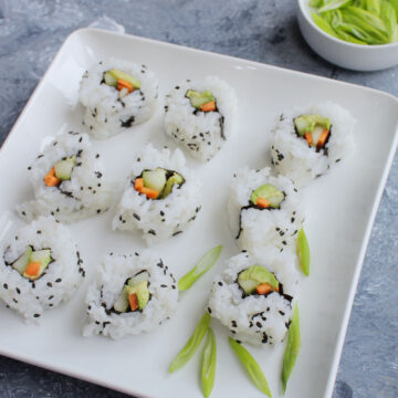 vegetarian sushi rolls garnishes with green onions.