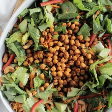 chopped romaine salad topped with chickpeas, cashews, and red bell pepper.