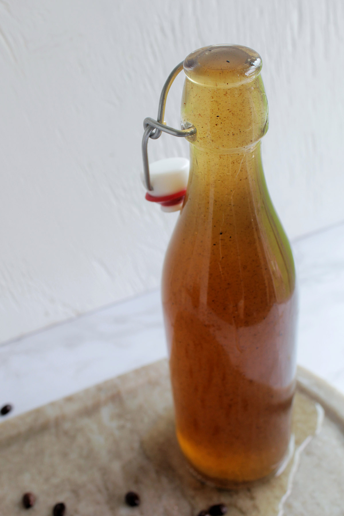 glass jar overflowing with vanilla simple syrup.