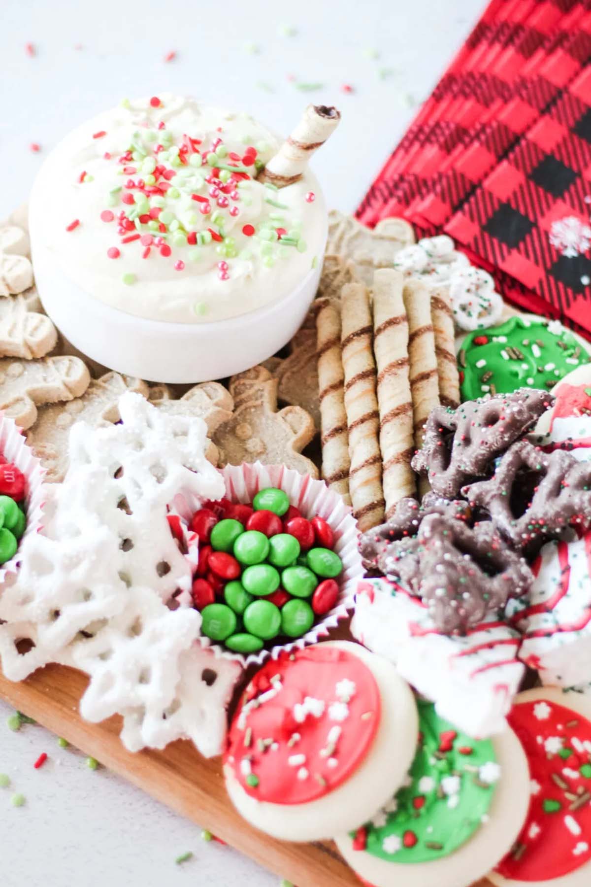 sugar cookie dip next to cookies and candy.