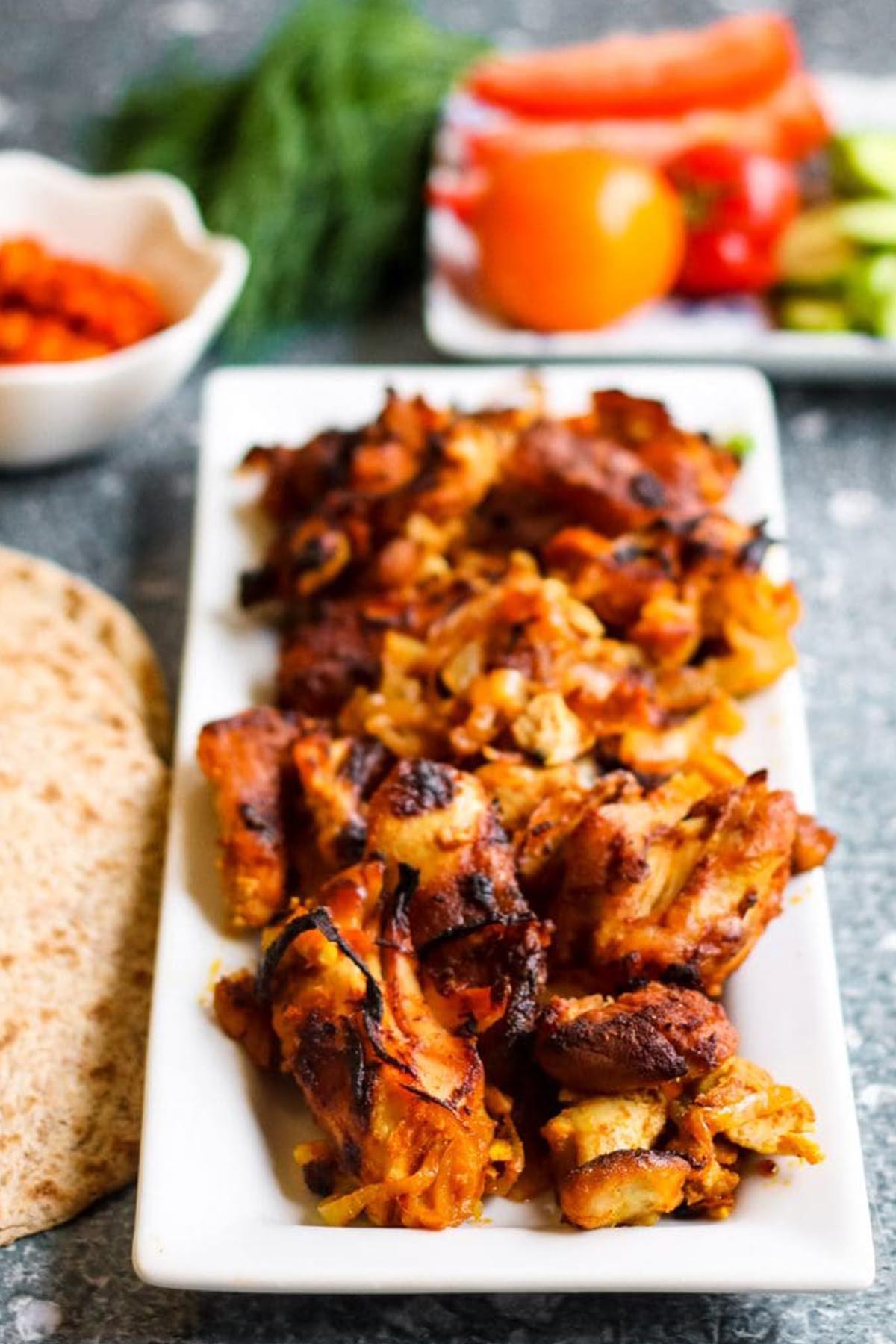 grilled chicken shawarma on a rectangular platter.