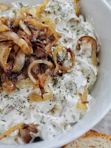 white dip topped with caramelized onions.