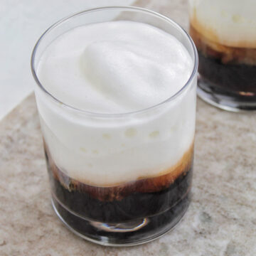 lowball glass filled with coffee and cold foam.