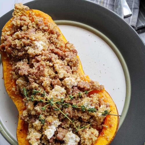 half of a butternut squash stuffed with sausage, goat cheese, and quinoa.