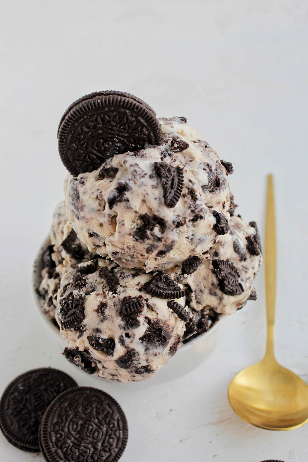 three scoops of oreo cookie ice cream in a small bowl.