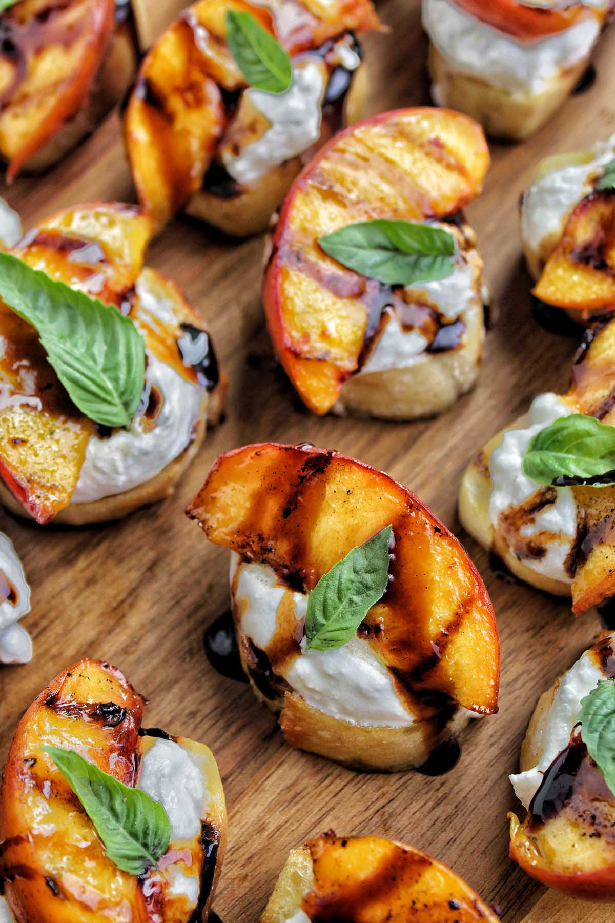 crostini bread topped with ricotta, grilled peaches, and balsamic glaze.