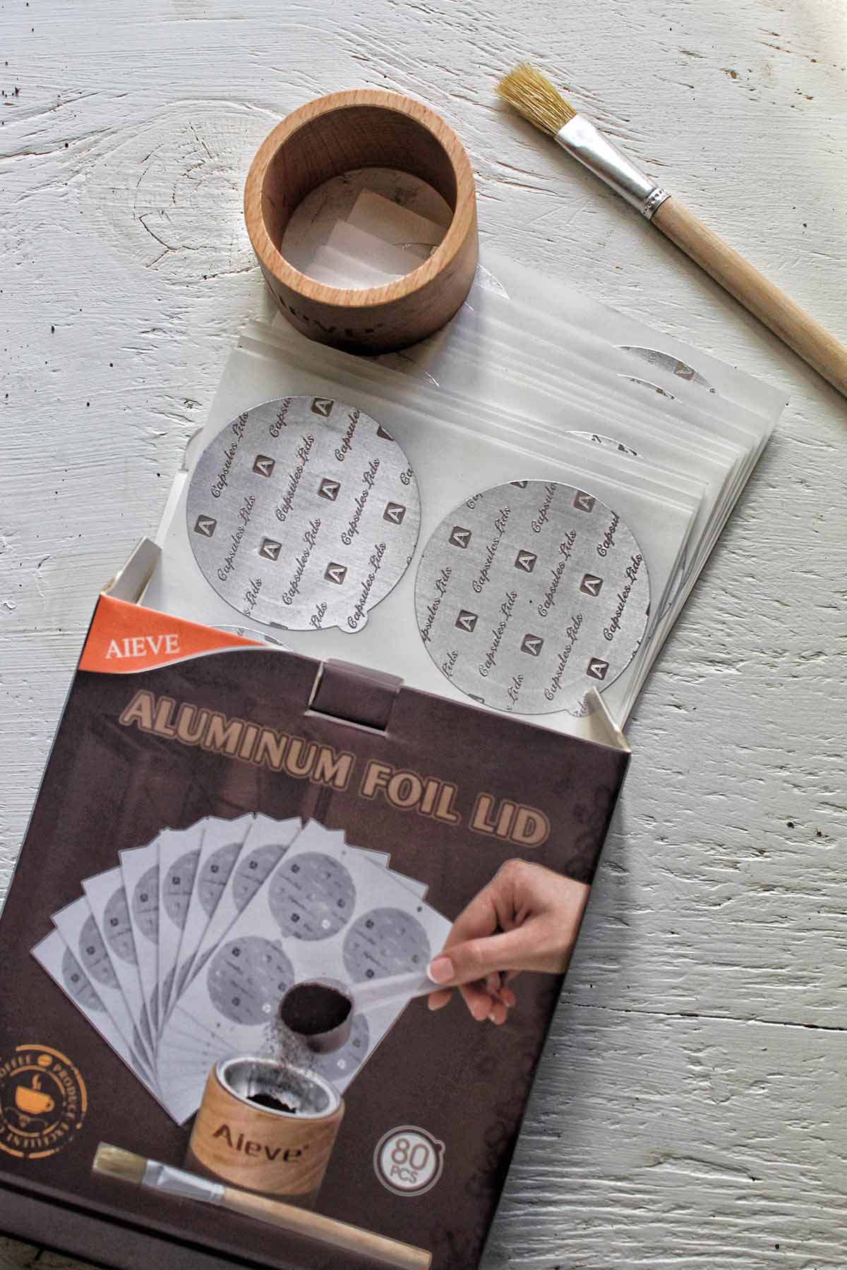 aluminum foil lid kit with a brush, wooden holder, and foil lids.