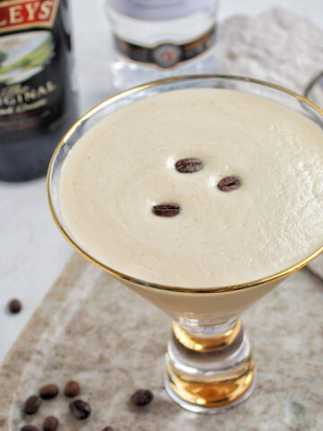 baileys espresso martini in a gold rimmed glass.