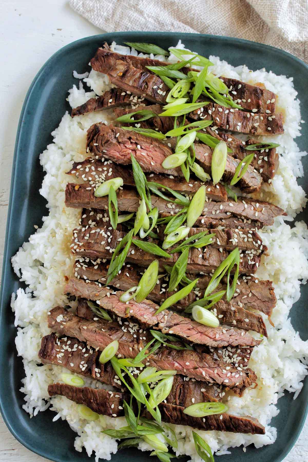 serving tray topped with rice and grilled steak.