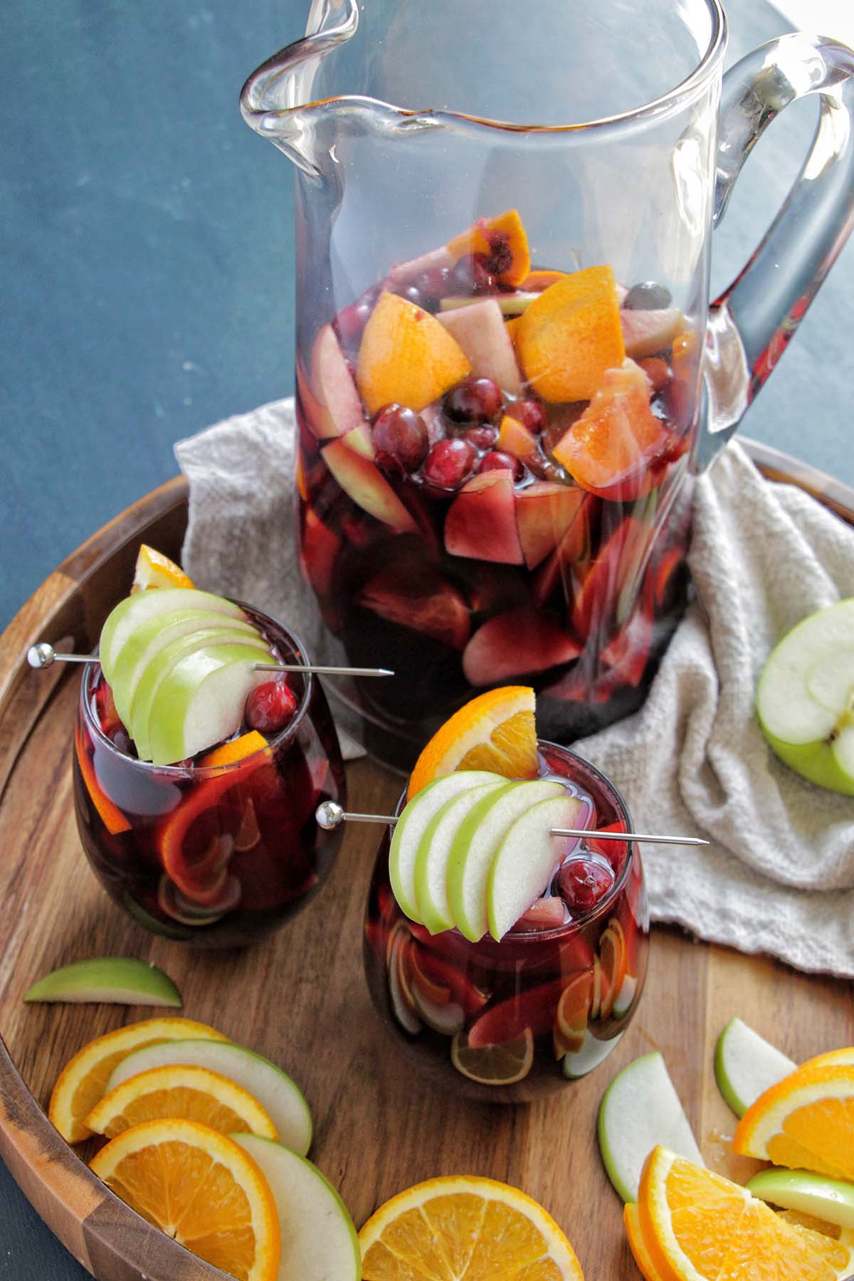 two wine glasses and pitcher filled with red wine sangria.