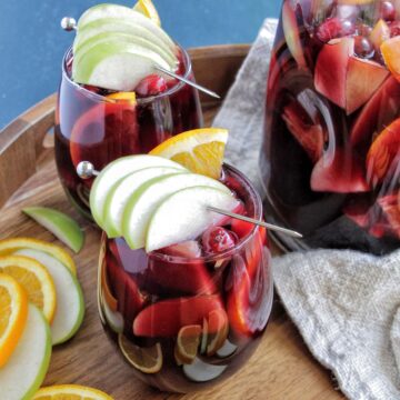 two wine glasses filled with red wine sangria.