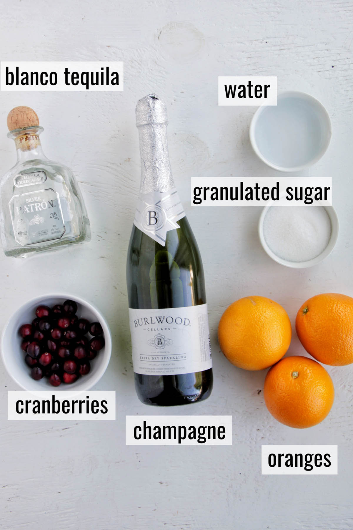 champagne and tequila cocktail ingredients with labels.