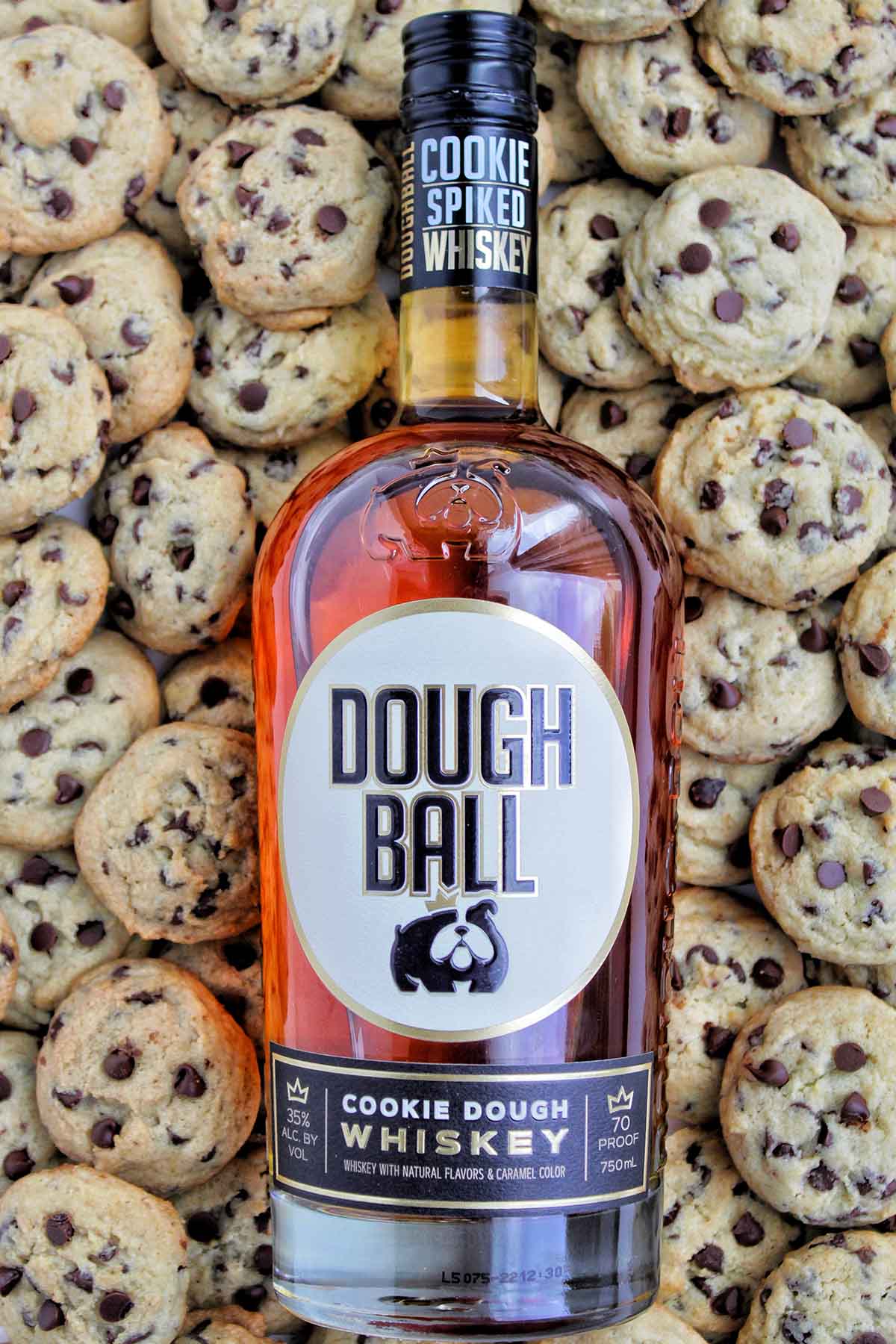 Dough Ball whiskey cocktail bottle on top of chocolate chip cookies.