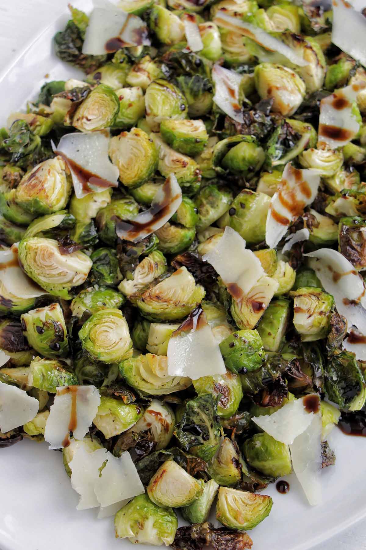 roasted brussel sprouts topped with balsamic glaze and parmesan cheese.