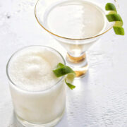 frozen coconut daiquiri in a low ball glass and classic coconut daiquiri in a martini glass.