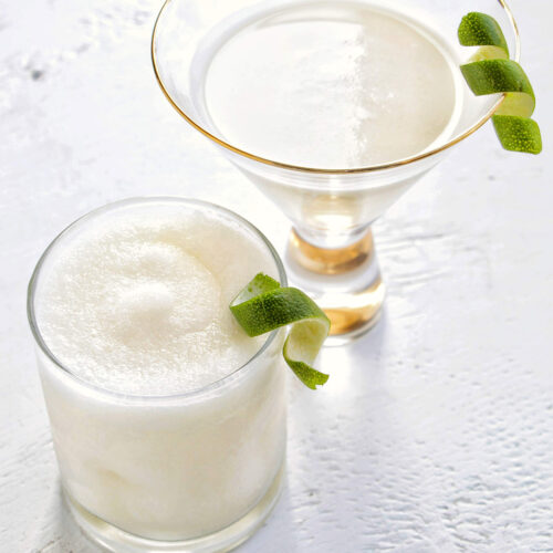 frozen coconut daiquiri in a low ball glass and classic coconut daiquiri in a martini glass.