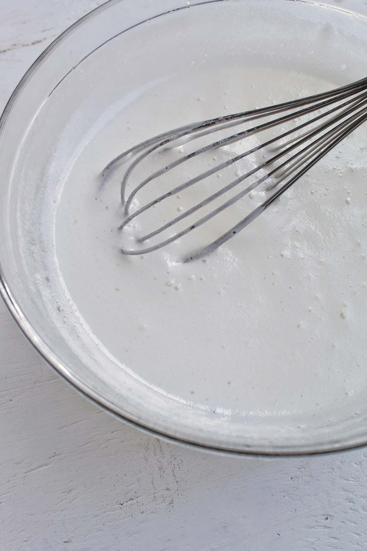 cooked egg whites and sugar in a bowl.