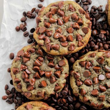 chocolate chip cookies laying on coffee beans.