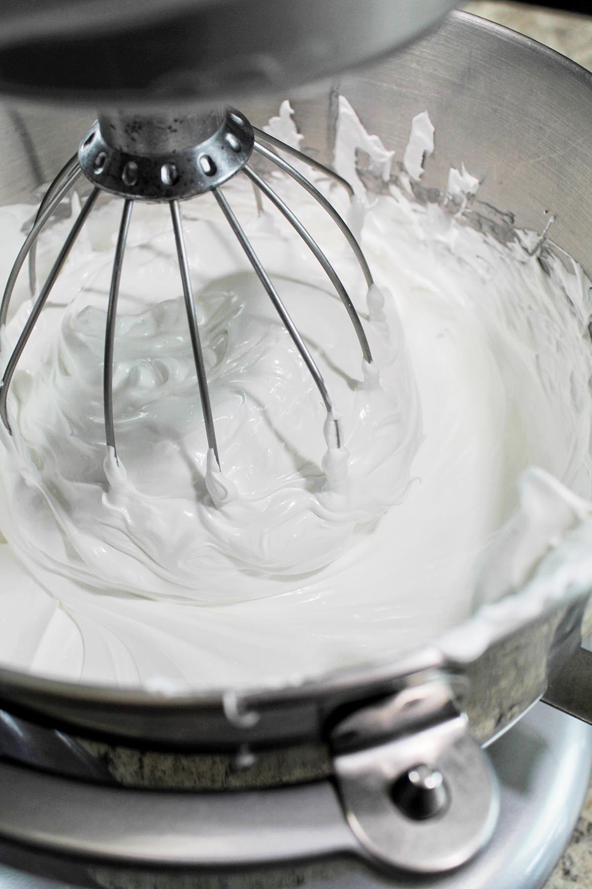 meringue whisking in an electric stand mixer.