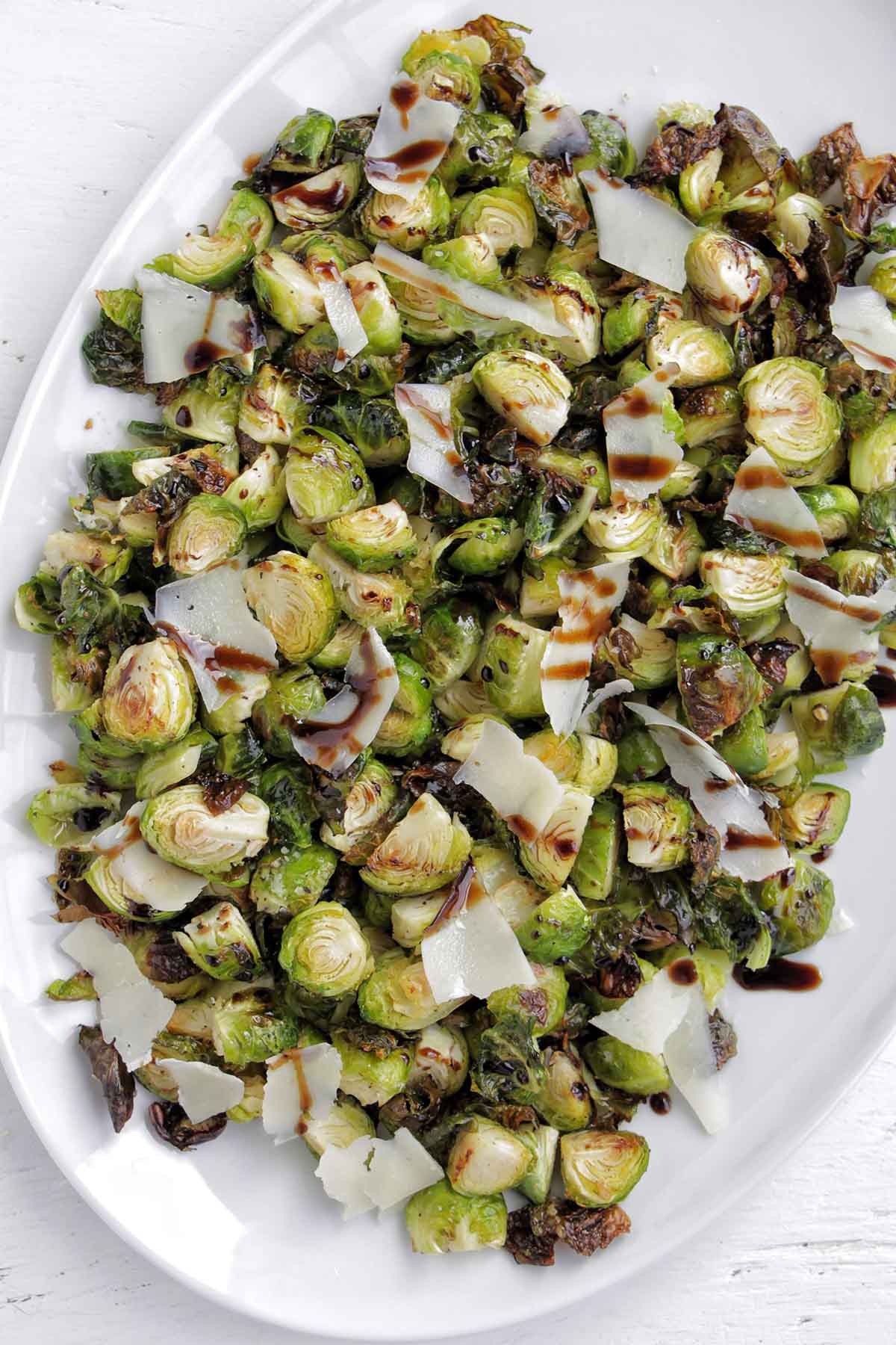 roasted brussel sprouts on a large white serving platter.