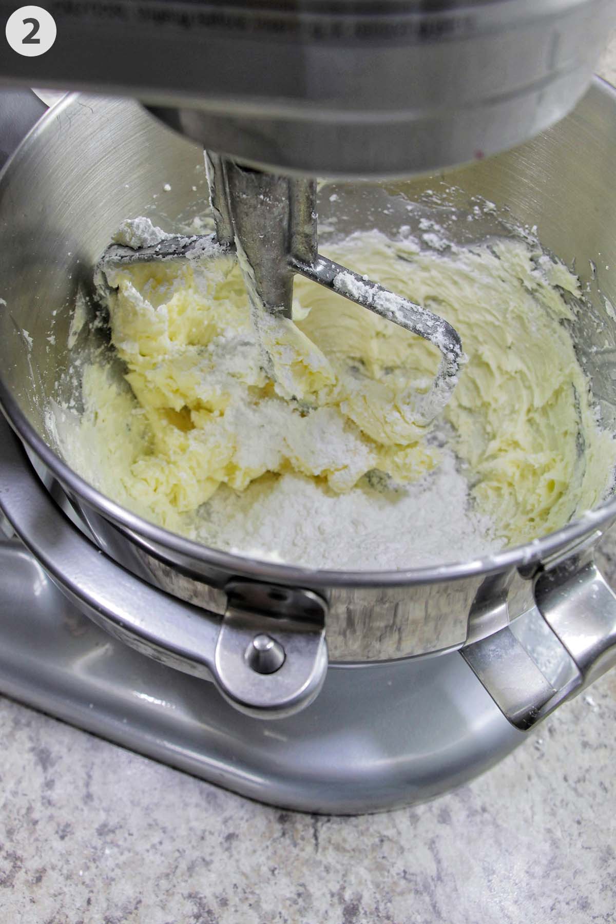 numbered photo showing confectioners' sugar in a mixer with creamed butter.