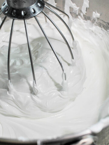 meringue whisking in an electric stand mixer.