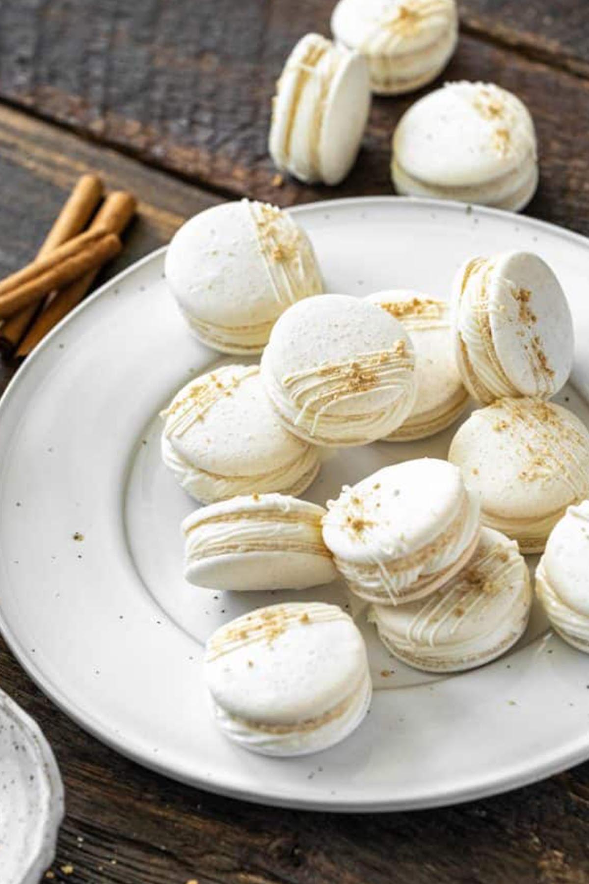 apple pie macarons on a white serving platter.