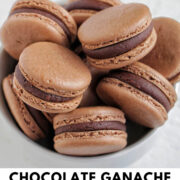chocolate macarons filled with ganache filling sitting in a bowl.