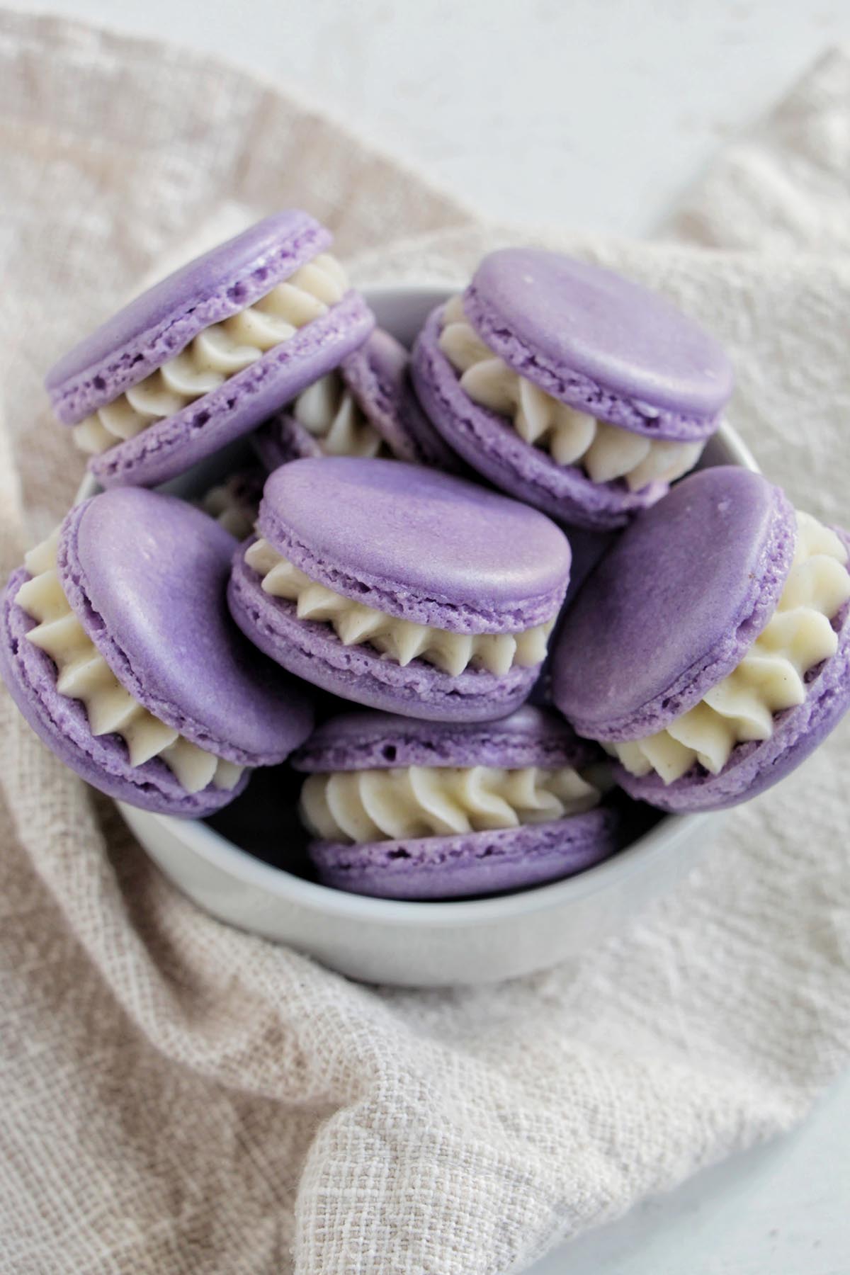 bowl filled with purple French macarons filled with buttercream.