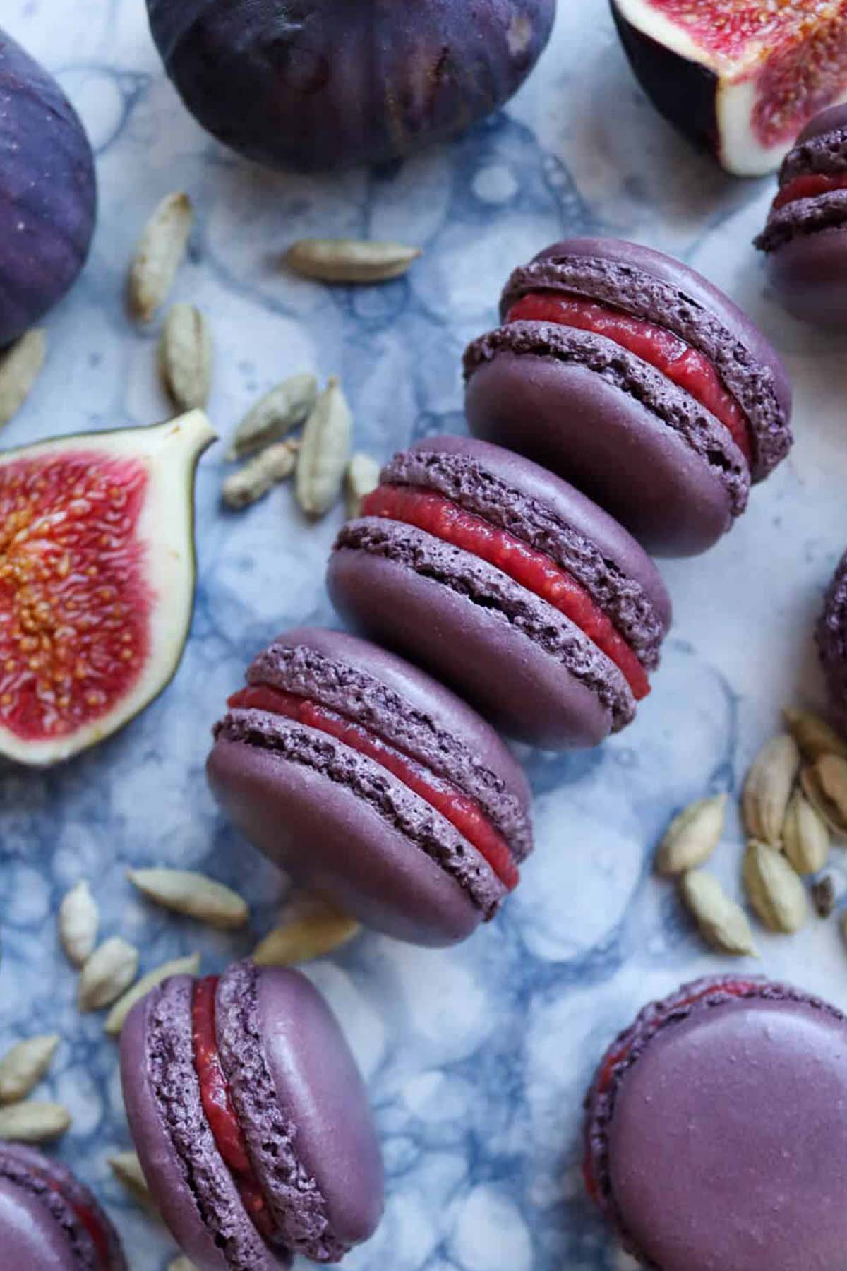 purple macaron shells filled with a pink fig filling.