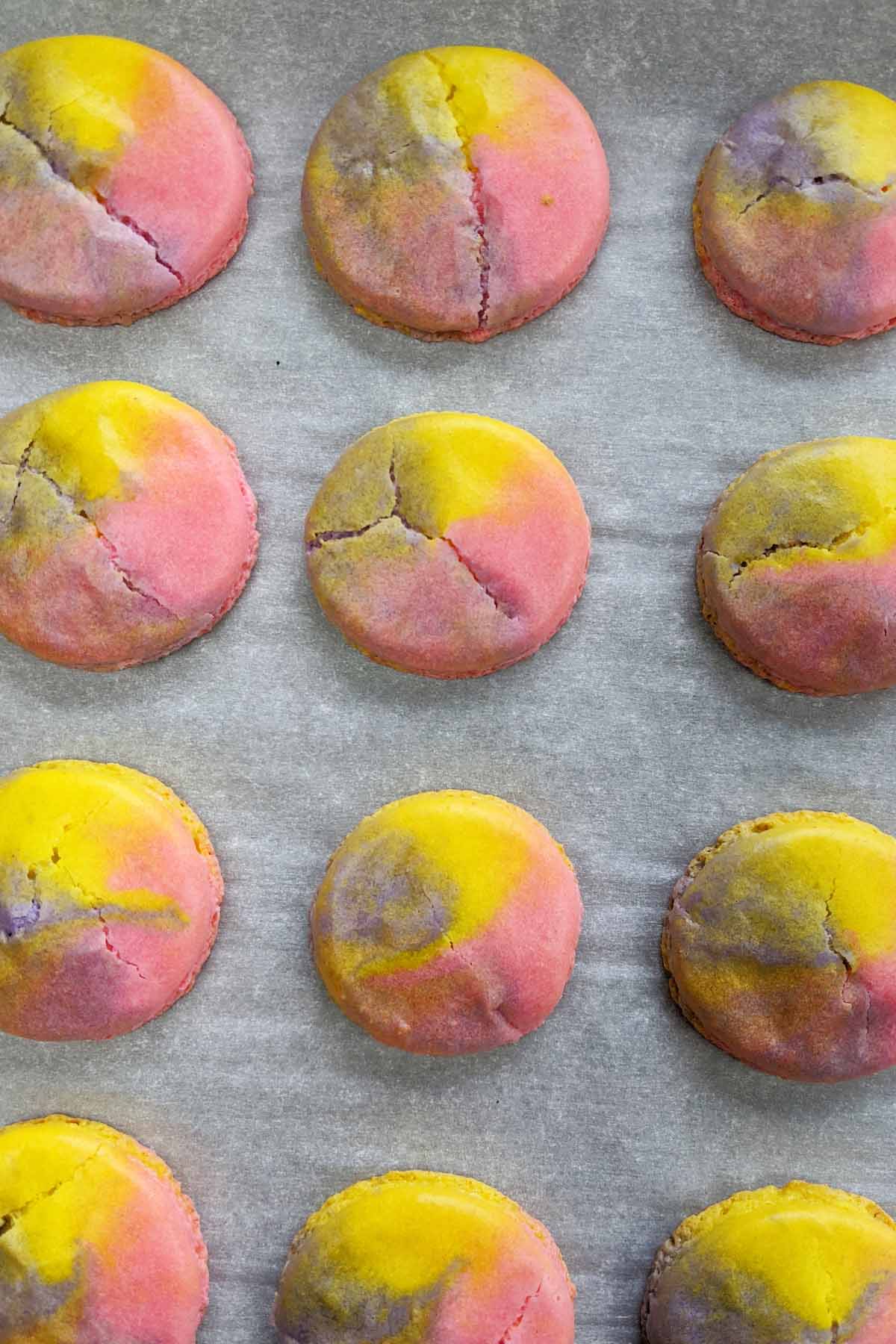 tie dye macarons with cracks on top.