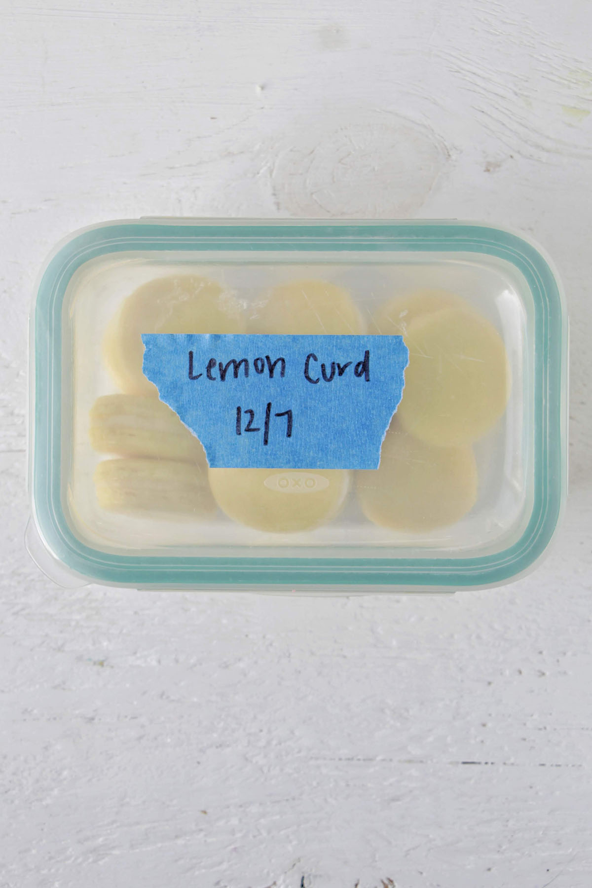 lemon curd macarons in an airtight storage container.