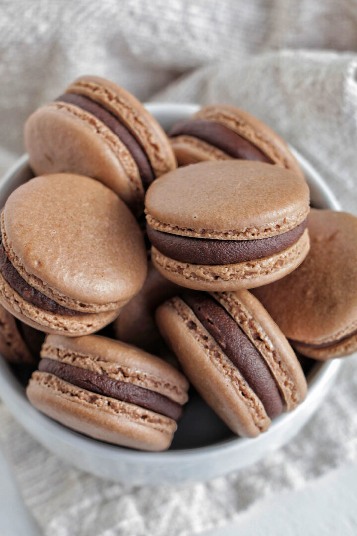 bowl filled with ganache filled macarons.