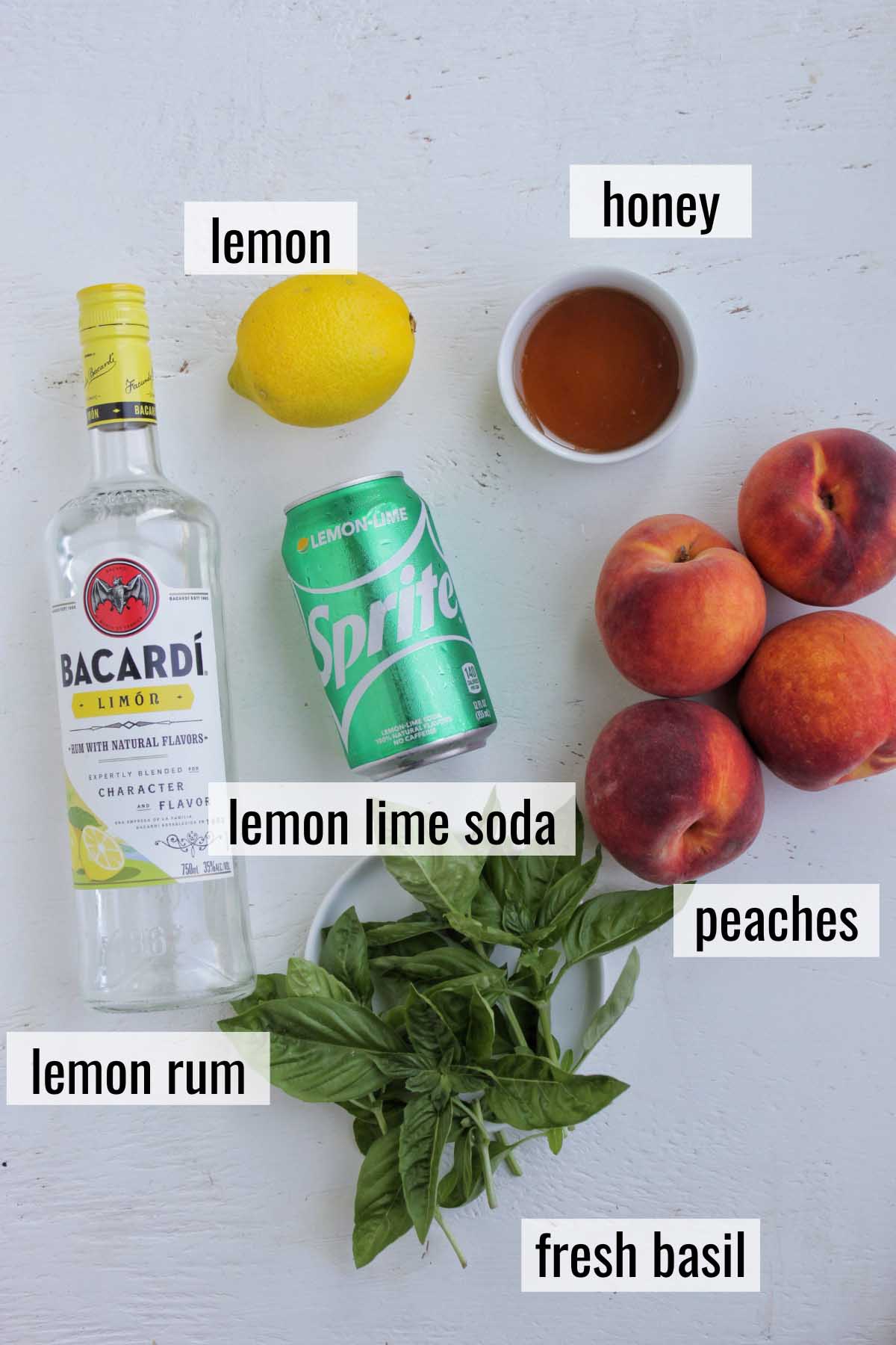 peach and lemon rum cocktail ingredients with labels.