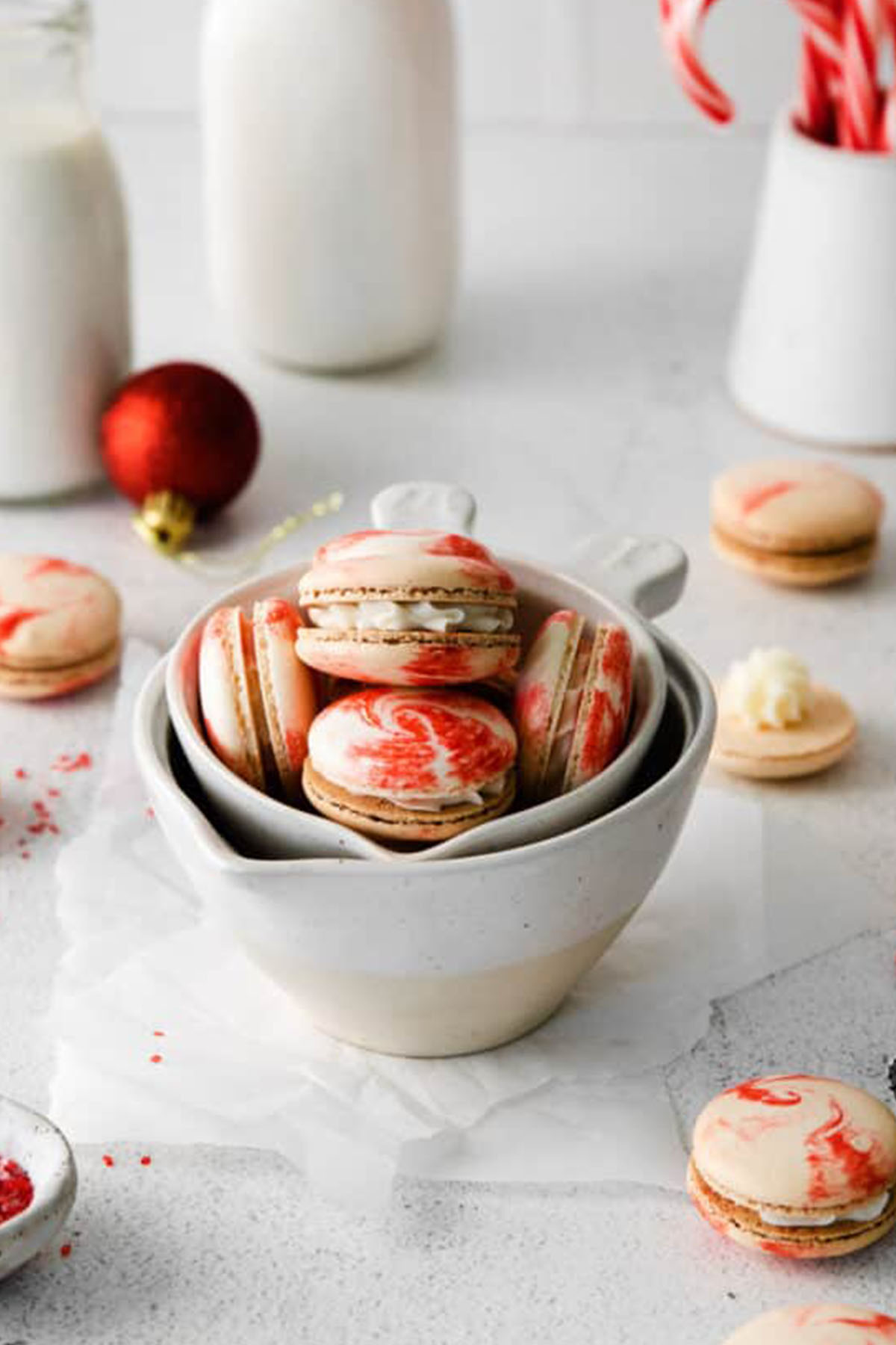 peppermint macarons with red and white swirled macaron shells.