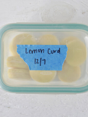 storage container holding yellow macarons labeled lemon curd.