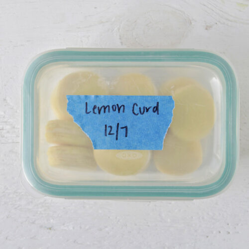 storage container holding yellow macarons labeled lemon curd.