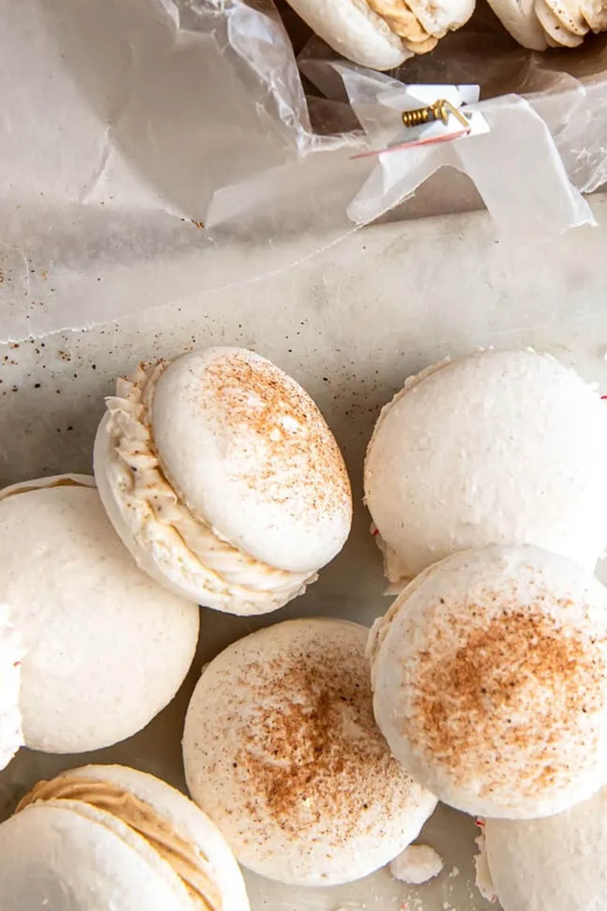 white shelled macarons decorated with cinnamon.