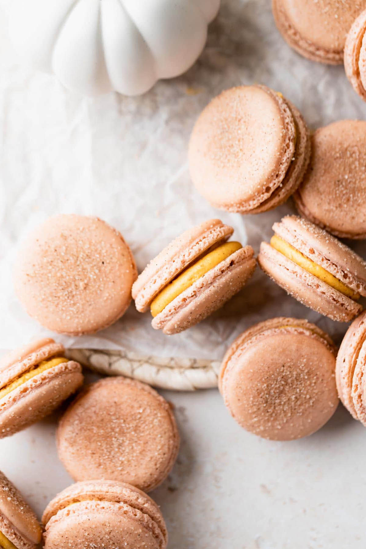 light brown macaron shells topped with cinnamon and sugar mixture.