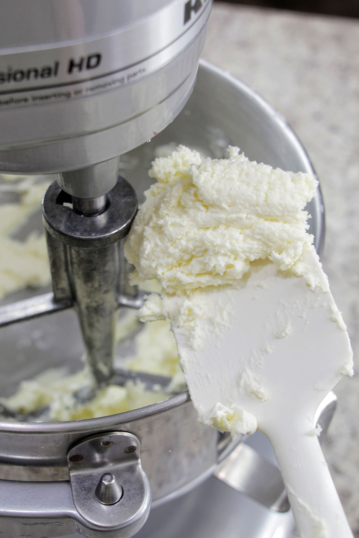 beaten butter and cream cheese on a silicone spatula.