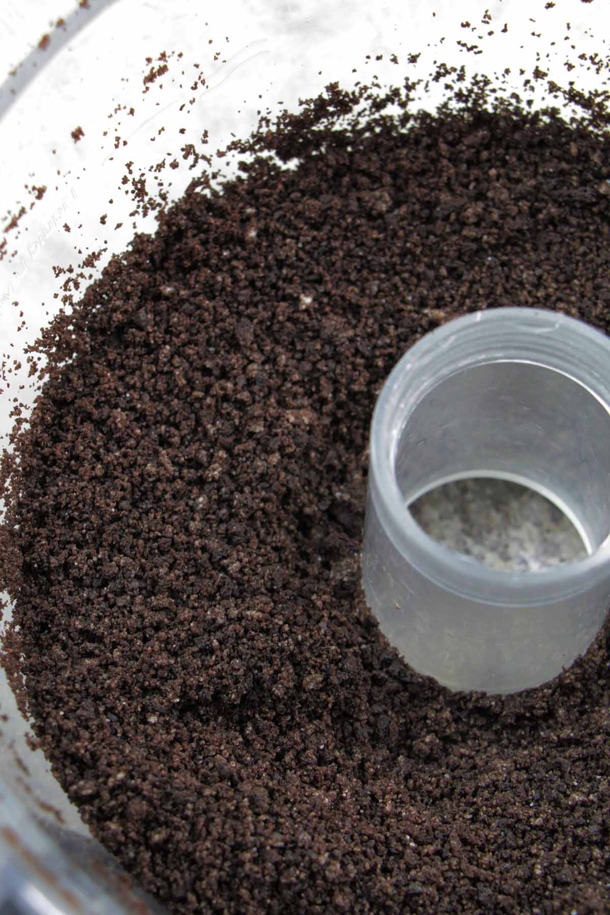 finely ground Oreo cookies in a food processor bowl.